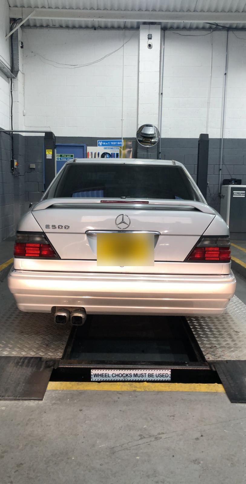 Mercedes-Benz E500 on the four-post MOT test bay at Autoworks Bradford