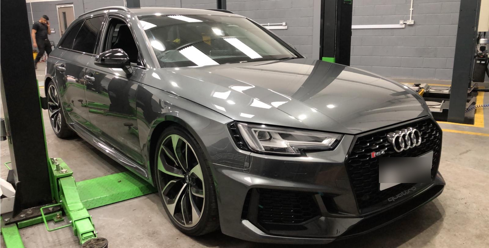 Grey Audi RS4 Avant on a two-post ramp at Autoworks Bradford