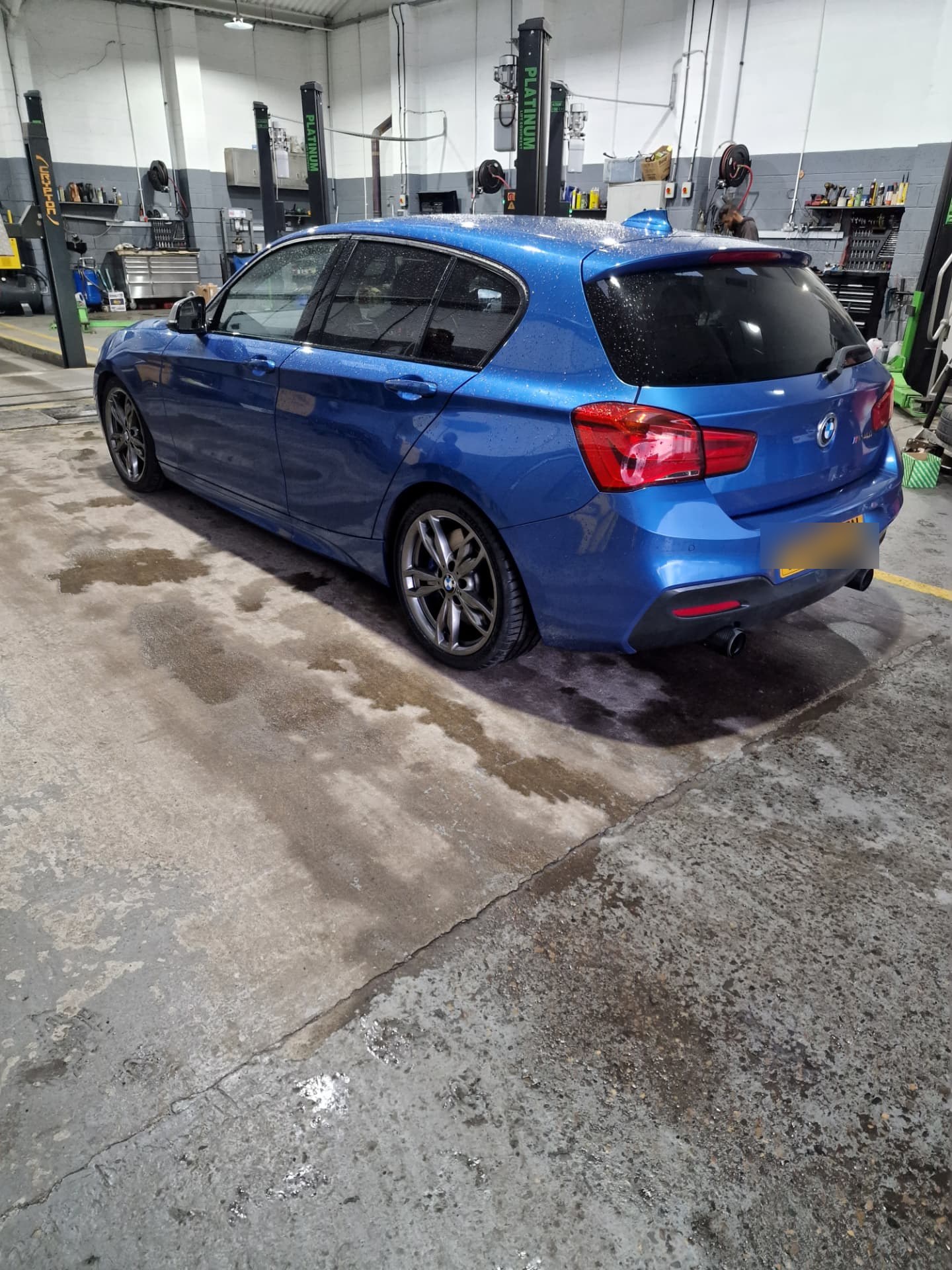 Blue BMW M140i in the Autoworks Bradford workshop after repairs