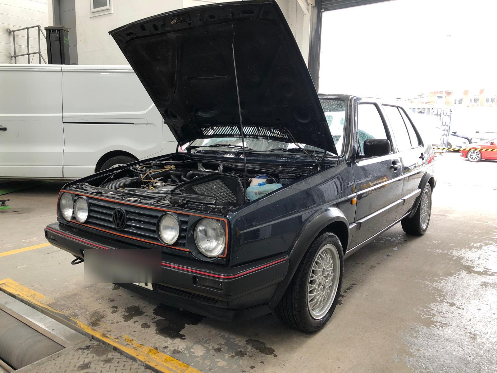 Classic VW Golf GTI Mk2 with the bonnet up in the workshop